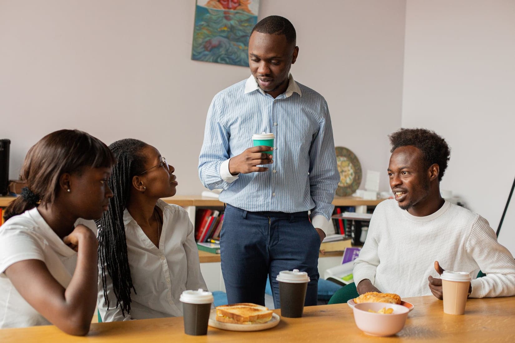 A small team talking over coffee in their office